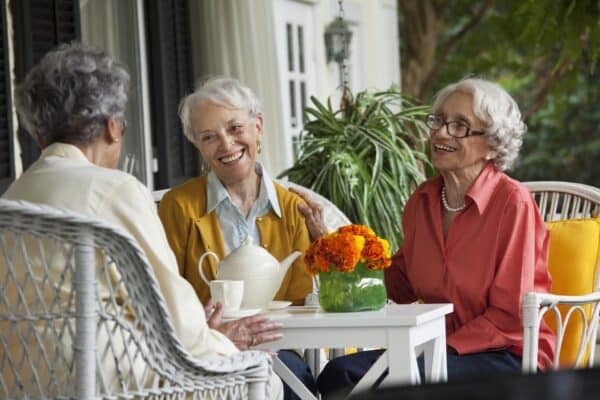 Women enjoying tea on porch